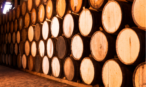Stacked whisky barrels.